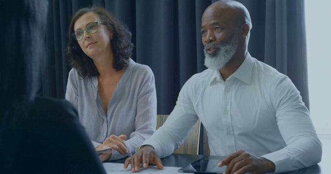 Image of financial data processing over diverse colleagues having meeting in office