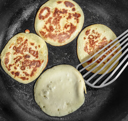 Delicious and Fluffy Pancakes Cooking in a pan
