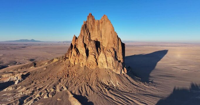 A breath-taking, high-flying orbital aerial shot of the sacred &ldquo;Ship Rock&rdquo;, a massive, monolithic monadnock, towering above the high desert plain of the Navajo Nation, in New Mexico, United States.