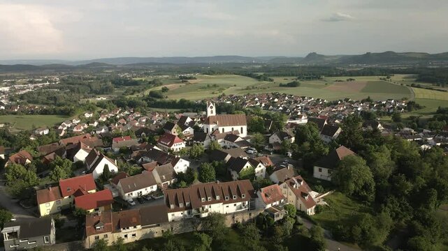 Drone footage revealing the historic hilltop town of Aach in Baden-W&uuml;rttemberg. As the drone ascends, it showcases the charming old town and the surrounding village below.