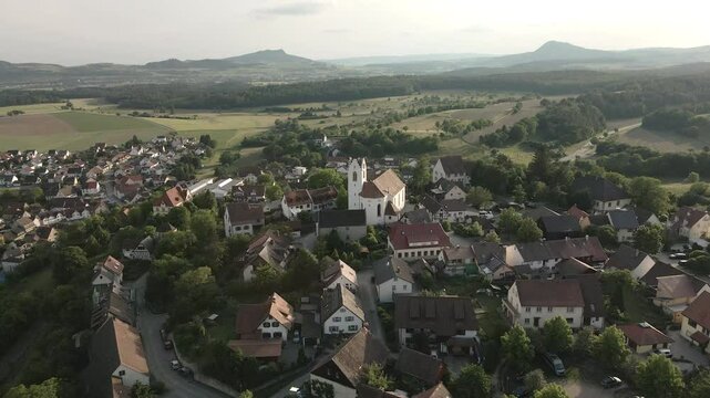 Drone footage flying over the historic old town of Aach, Baden-W&uuml;rttemberg, providing a detailed view of the rooftops, church tower, and the surrounding countryside.
