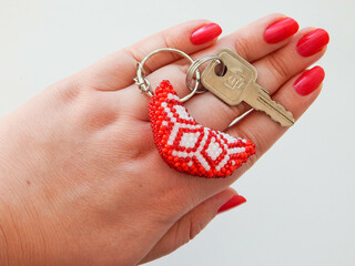 Red keychain in a female hand