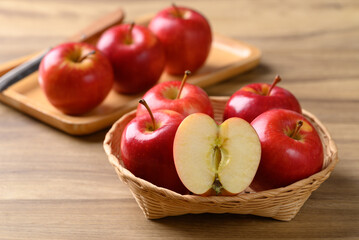 Red apple fruit (Gala apple) in basket on wooden background