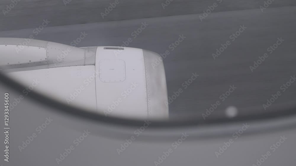 Poster view of airplane engine through window during flight on a cloudy day