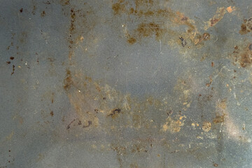 Rusty metal surface with oxidized stains and corroded patches. Aged industrial texture. Rough weathered details. Abstract background