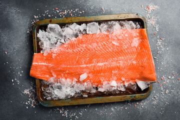 raw salmon or trout sea fish fillet on ice. Top view.