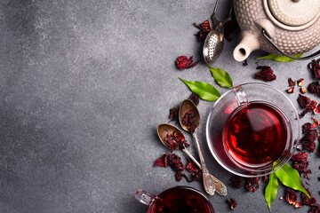 Cup of vitamin hibiscus tea with teapot on table. On stone background. Tea background. © Yaruniv-Studio