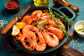 Pan with fried shrimps. Side view. Close-up. Cooking background.