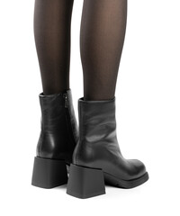 Women's shoes on a white background. Close up of a women's black leather chelsea boots on white background. Footwear for city, urban lifestyle or traveling. Concept of fashion, design and footwear.