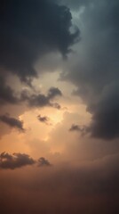 Obraz premium Dark clouds illuminated by warm sunlight create a dramatic sky background for mobile devices
