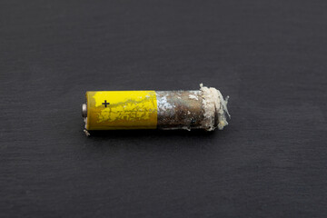 Obraz premium A worn-out electric battery. Oxidized and Leaked electric battery with white powder hydroxide or carbonate. This powder can be caustic and irritate skin and mucous membranes
