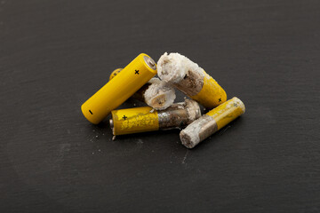 Used batteries with expired shelf life. Old oxidized and leaking batteries, leakage of alkaline...