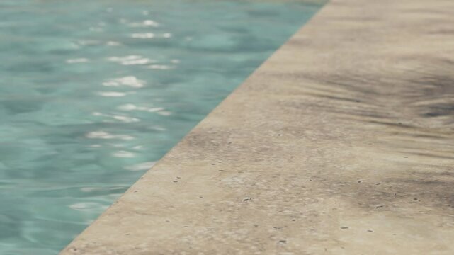 Luxury travertine floor on resort swimming pool with sunshine and palm shadow. Beauty and body care cosmetic brand advertising display in tropical aesthetic scene.