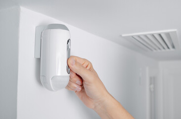 man connects the camera of a burglar alarm