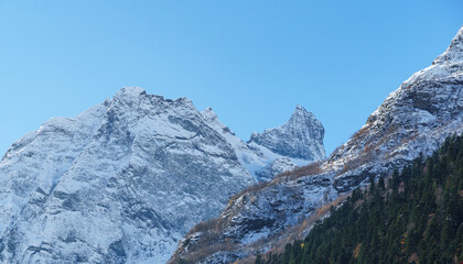 Picturesque landscape in Dombay with amazing snow-capped peaks and majestic blue slopes of North  Caucasus Mountains