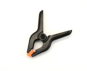 Black plastic clamp, isolated on a white background.