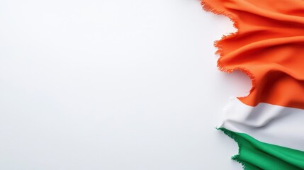 Orange, white, and green fabric draped on a white background. Copy space available
