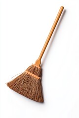 A simple, rustic broom with a light brown wooden handle and a triangular head of dark brown bristles, set against a stark white background
