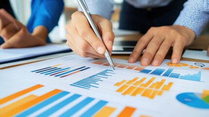 Business professionals analyzing data and charts during a collaborative meeting in a modern office