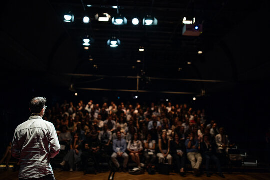 Speaker giving a talk on corporate Business Conference. Audience at the conference hall. Business and Entrepreneurship event.