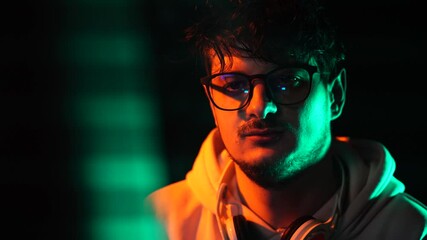 Portrait of Software Programmer or Hacker With Glasses in Front of Monitor Screen in Dark Room - Powered by Adobe
