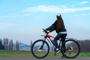girl on a bicycle against the sky