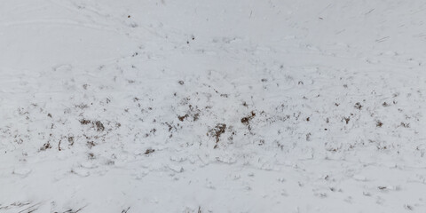 panorama view from above on texture of snow covered road in the winter forest