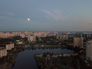 Aerial View of Kyiv, Ukraine – Dnipro River, Bridges and Sunset Above the Clouds