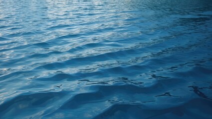Obraz premium Calm blue water surface texture suitable for backgrounds, banners, or 3D mapping applications with gentle ripples and reflections.