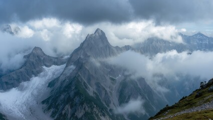 Fototapeta premium Majestic mountain peaks rising through clouds with dramatic lighting and rugged terrain capturing the essence of alpine adventure and tranquility.