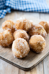 Traditional Carnival fritters or buñuelos de viento on wooden table
