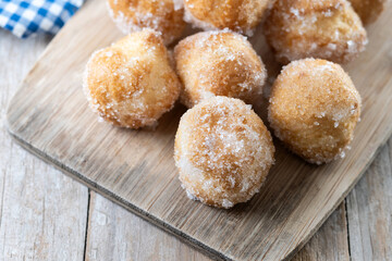 Traditional Carnival fritters or buñuelos de viento on wooden table