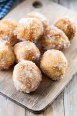Traditional Carnival fritters or buñuelos de viento on wooden table