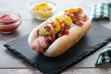 Sonoran hot dog. Traditional Mexican hot dog on wooden table