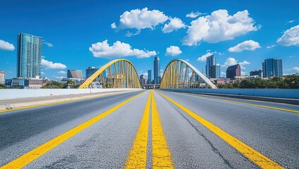 Fototapeta premium Empty Highway Leading to Modern City with Yellow Bridge Under Blue Sky