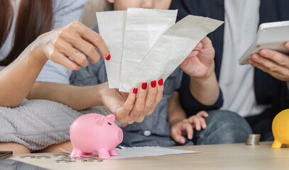 Family analyzing bills together, focusing on savings and expenses