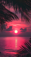 Photograph of a dark pink sunset over the ocean with palm leaves
