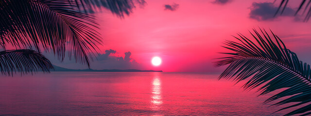 Photograph of a dark pink sunset over the ocean with palm leaves
