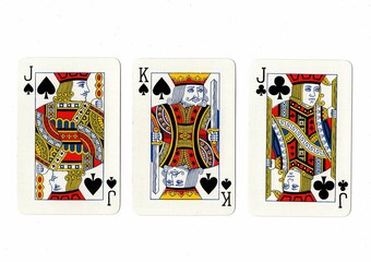 A hand of three playing cards isolated on a white background.