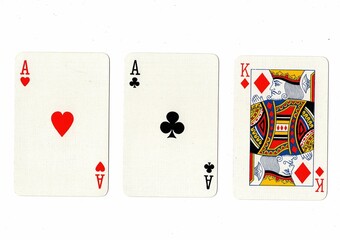 A hand of three playing cards isolated on a white background.