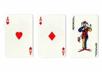 A hand of three playing cards isolated on a white background.