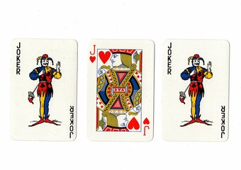 A hand of three playing cards isolated on a white background.