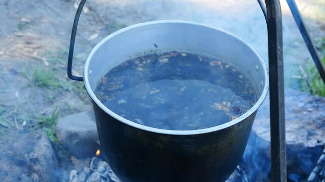 Taste of nomadic life tea and food prepared over an open fire in nature Simplicity of bushcraft cooking reflects centuries-old survival techniques passed through generations Concept of cooking fire