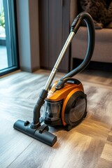 A modern vacuum cleaner in an indoor setting, featuring an orange design, placed on a wooden floor.