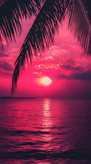 Photograph of a dark pink sunset over the ocean with palm leaves
