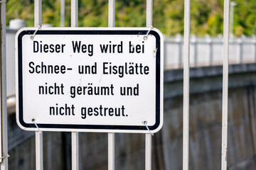 A traffic sign at Rappbode Dam (Harz Mountains, Germany) warns that the road will not be cleared nor gritted in snowy and icy conditions. The Rappbode Dam is the highest dam in Germany.