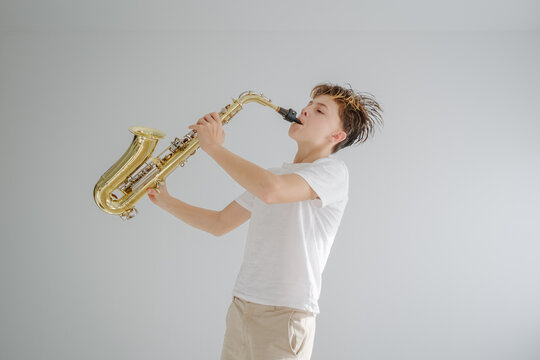 Young musician passionately playing jazz on a saxophone