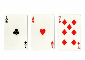 A hand of three playing cards on a white background.