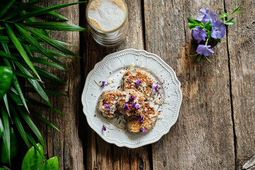 Banana pancakes with chocolate decorated with violets.