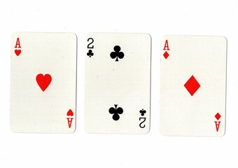 A hand of three playing cards showing a pair on a white background.